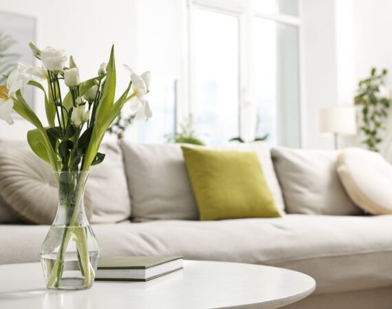 Feng,Shui.,Vase,With,Flowers,And,Book,On,White,Table